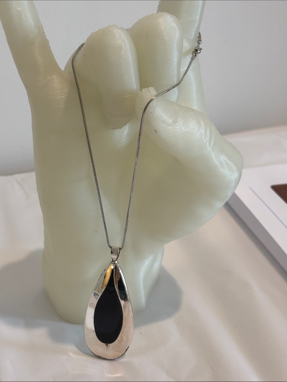 Silver tear drop necklace black inset 16” chain NSD marking on back 1.3oz